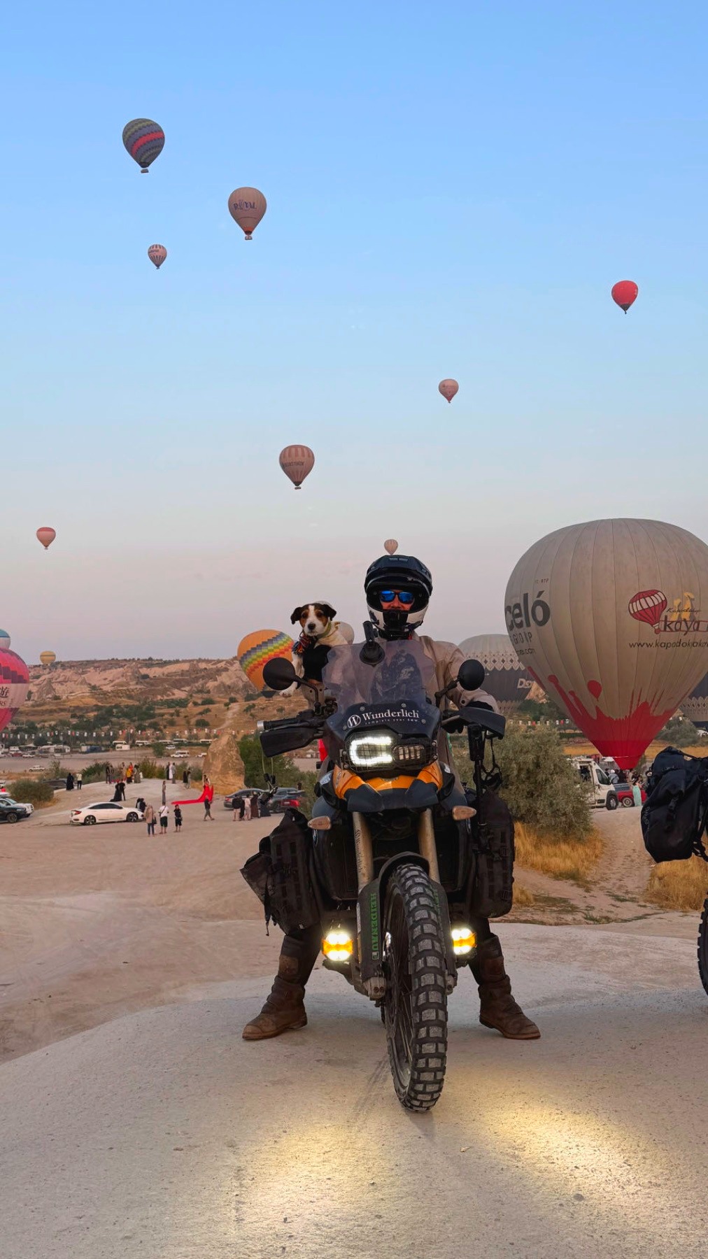The motorcycle on the road below hot air balloons