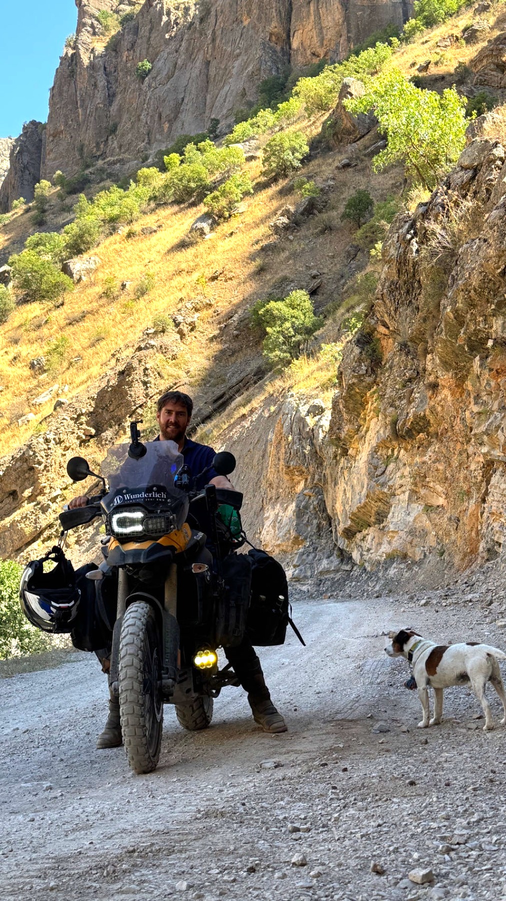 The motorcycle on a gravel road in a deep gorge