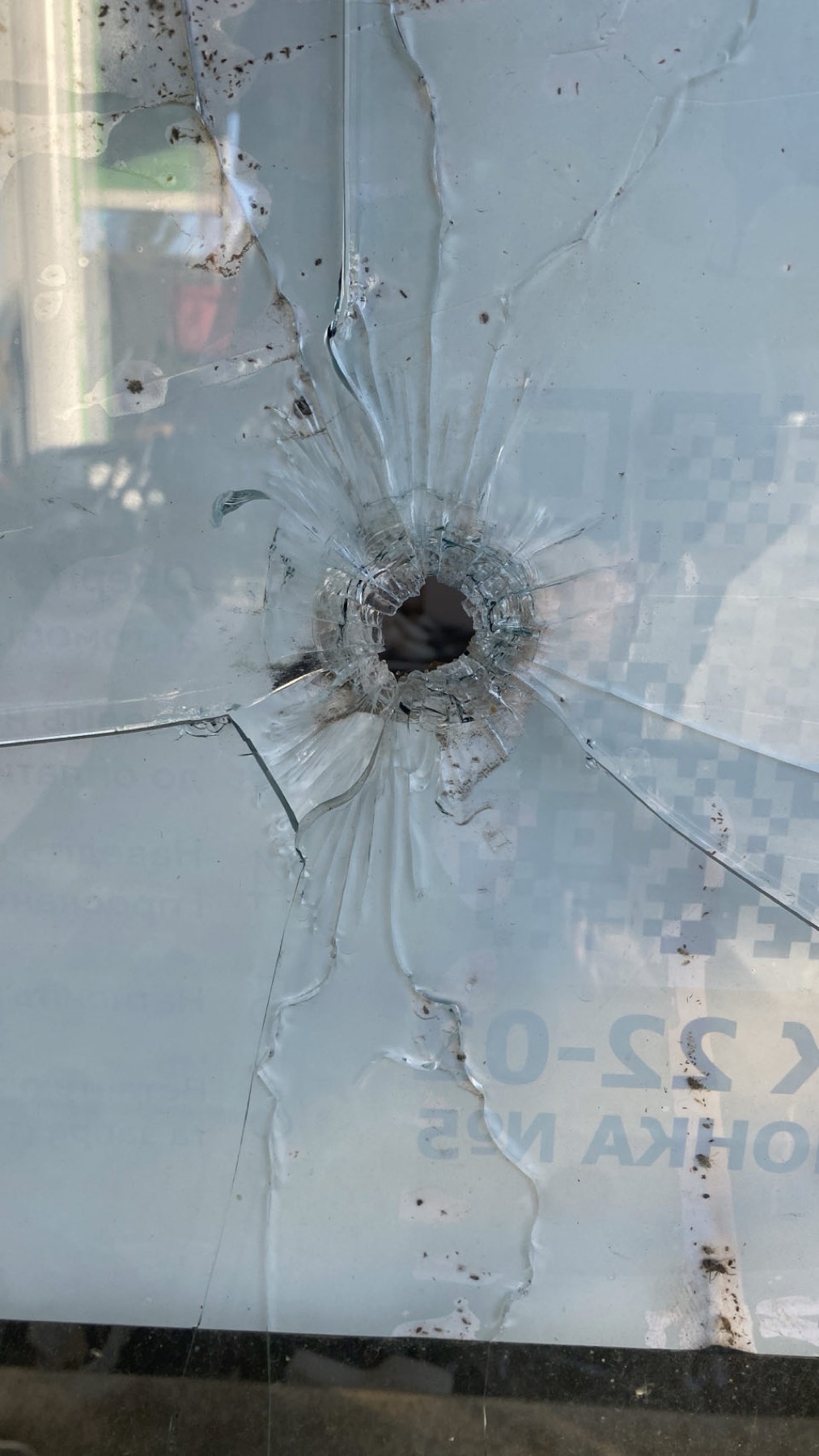 A bullet hole through a shop window