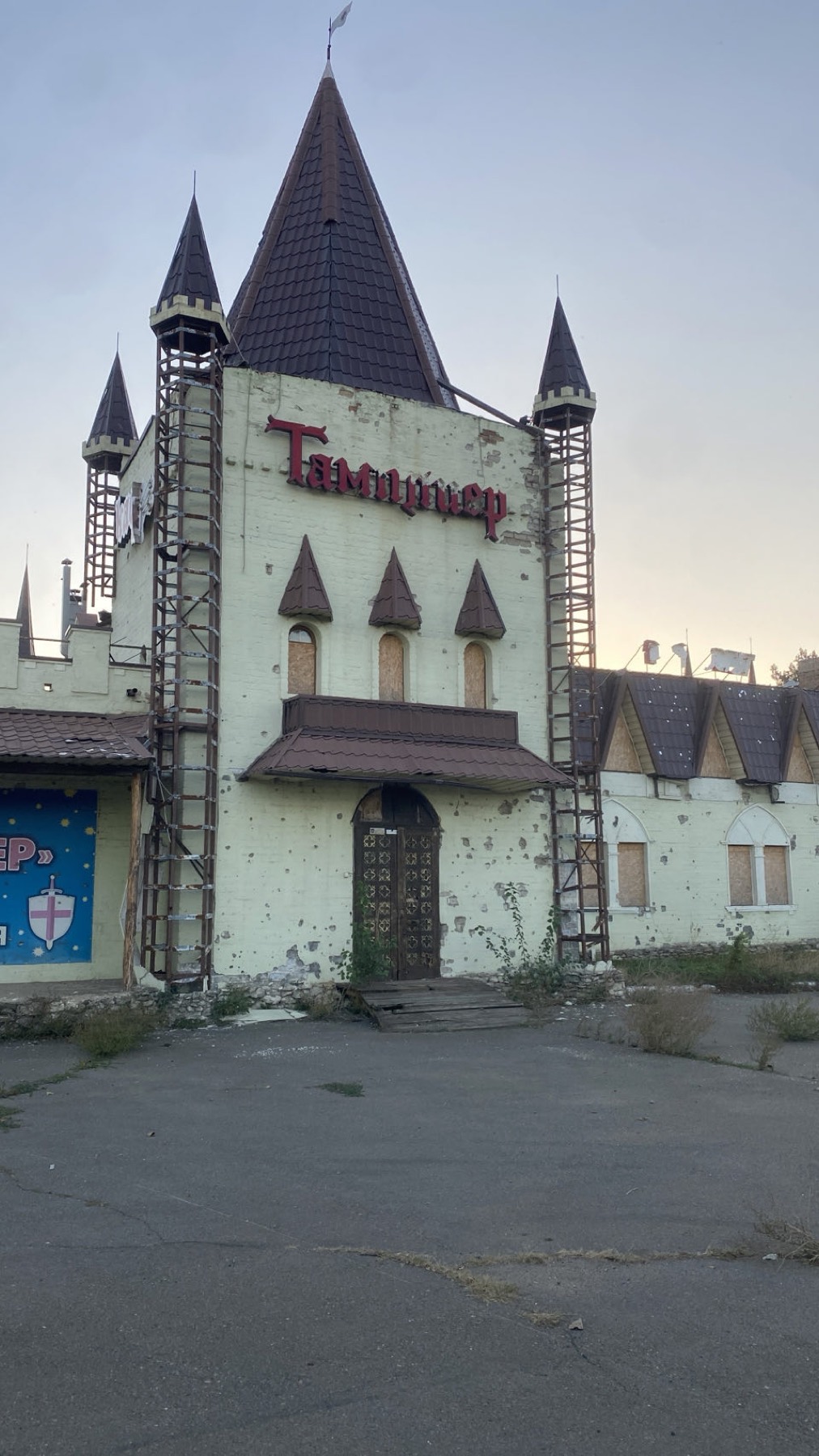 A shelled building with empty window frames