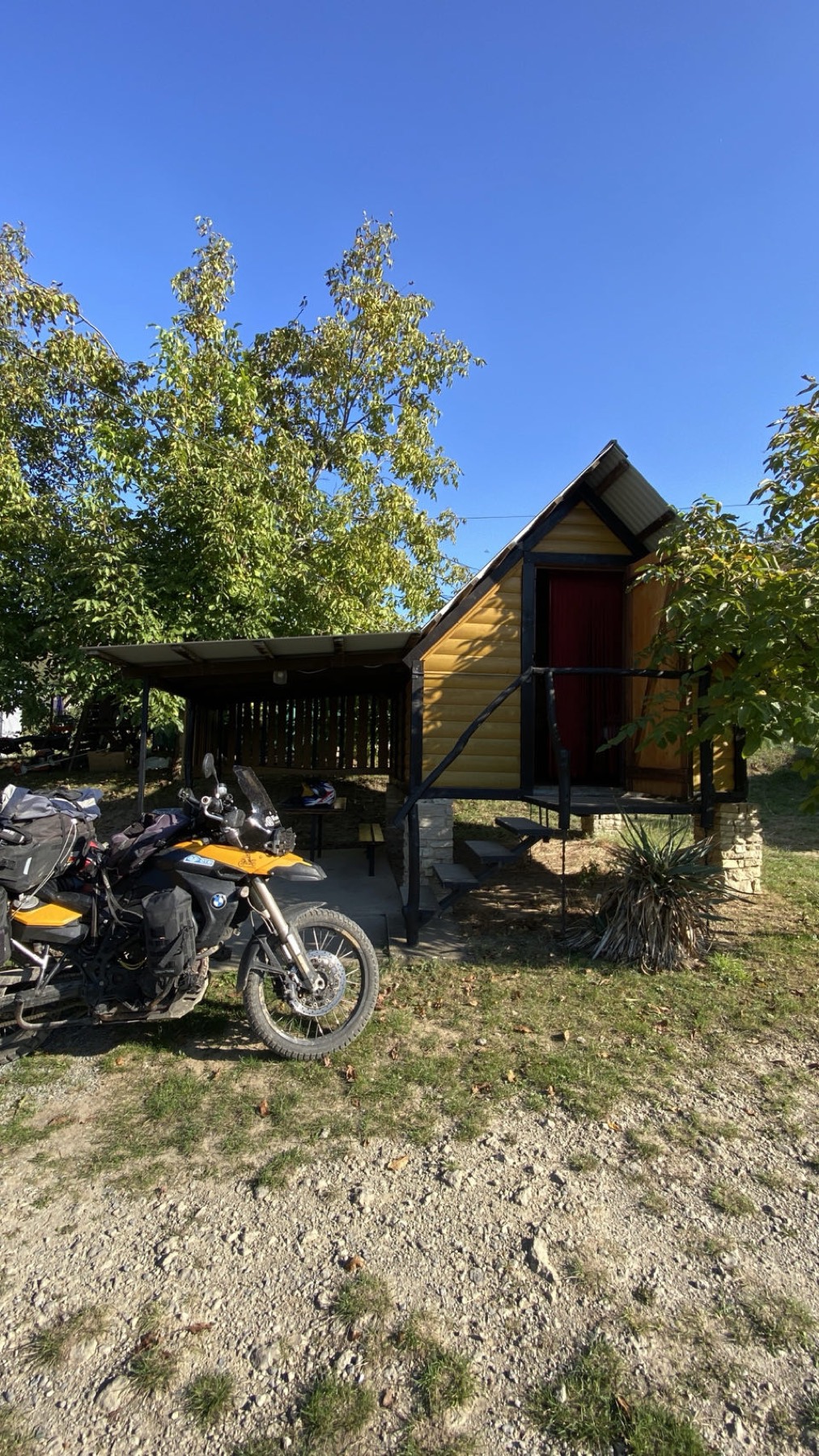 The motorcycle parked beside a wooden cabin