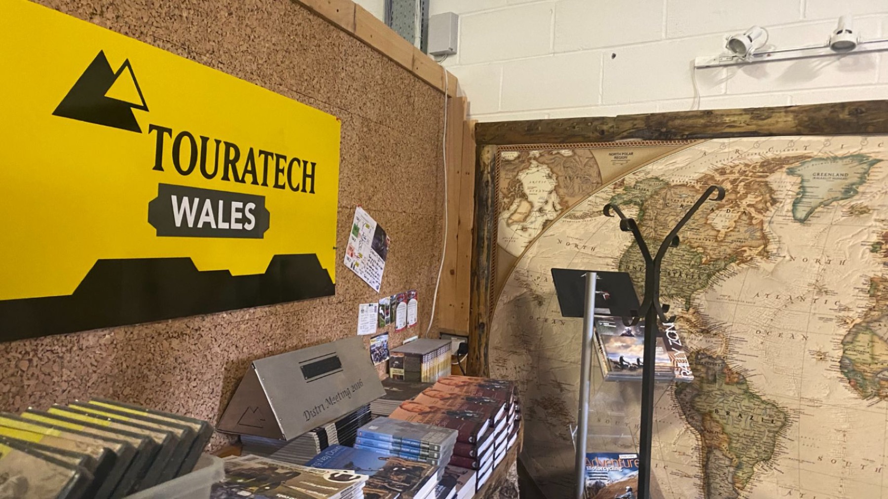 The Touratech Wales sign above the workshop counter