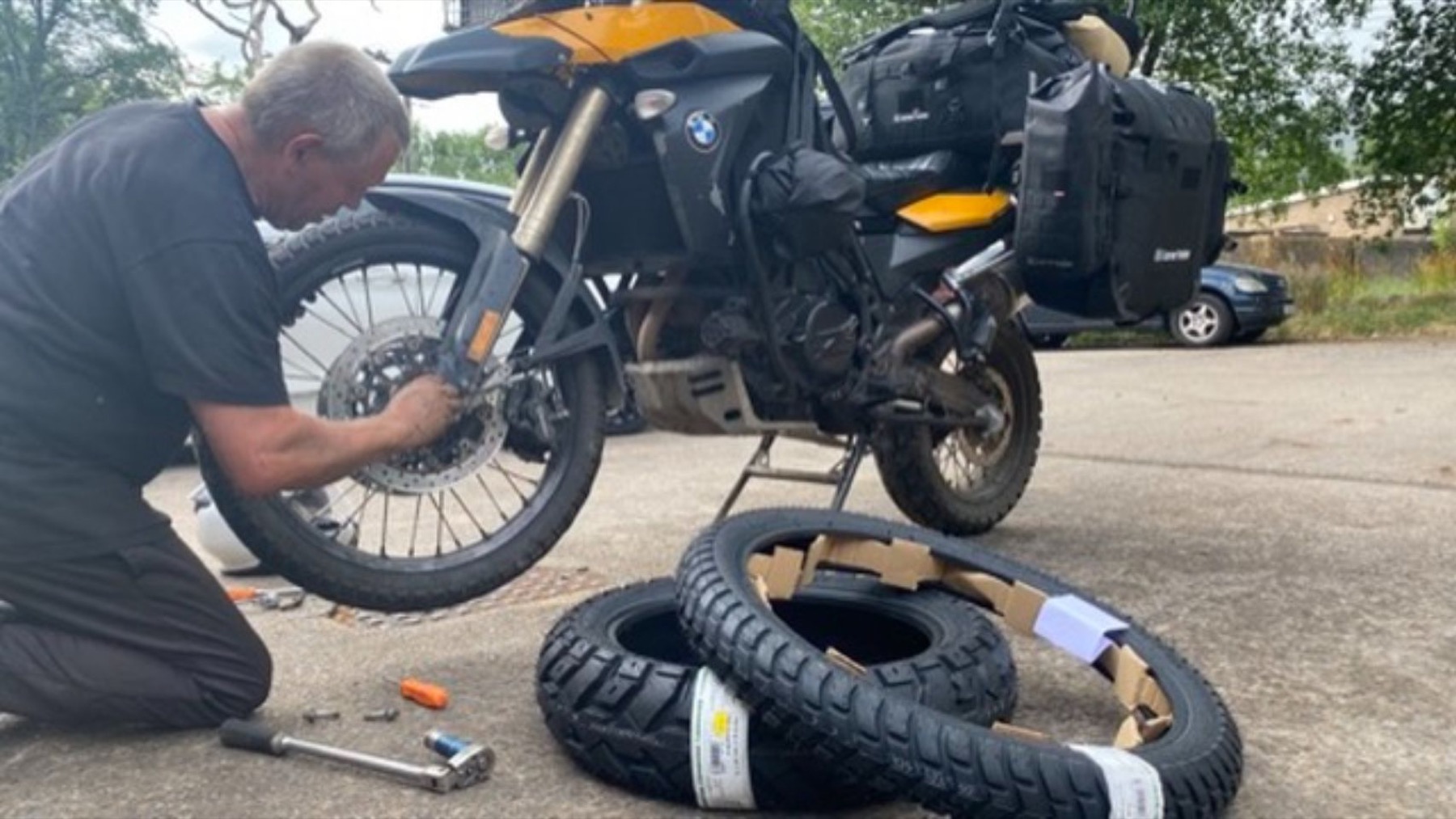 A tyre being changed on the floor of the workshop yard